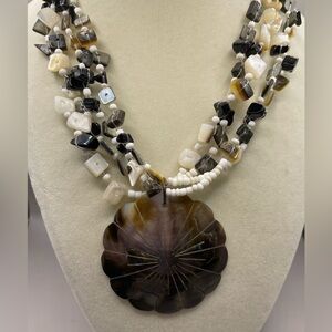 Round shell pendant on beaded multi strands. 16 inches with 3 inch extender